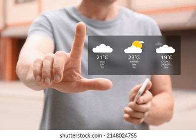 Man using weather forecast application on virtual screen outdoors, closeup