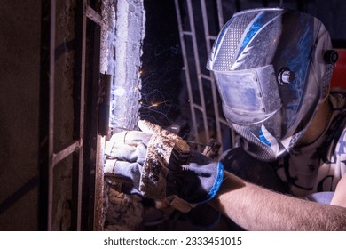 a man using the welding machine in night