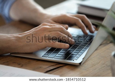 Man using wireless computer seated at workplace desk. Male hands typing letter e-mail close up view laptop keyboard. Freelance work from home, on-line education, business, modern technology concept