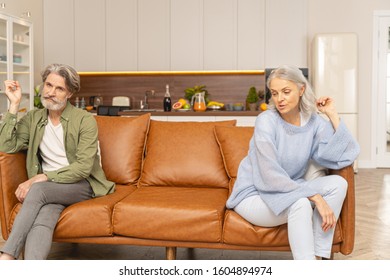 Man With A Vacant Stare Resting His Elbow On The Couch