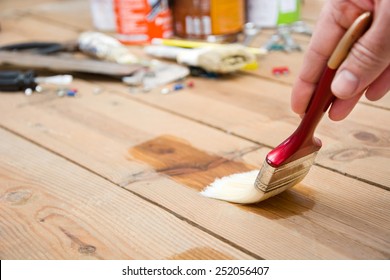 Man Varnishing A Wood