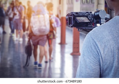 man videographer takes video with camera on the stabilizer - Shutterstock ID 673489180