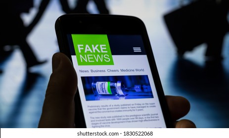 Man Viewing A Fake News Website On The Coronavirus Vaccine With People On The Move At The Busy Airport In The Background