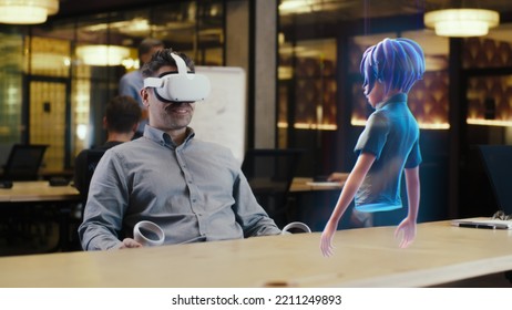 A Man With Virtual Reality Glasses Uses A Joystick To Connect The Video Chat With An Avatar Of A Girl Via Hologram In The Metaverse. Augmented Reality Concept.