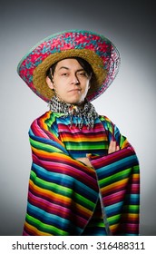 Man In Vivid Mexican Poncho Against Gray