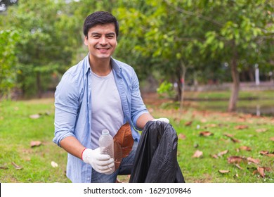 Man Volunteer Pick Garbage Bottle Plastic Clean Up Environment In Green Park.