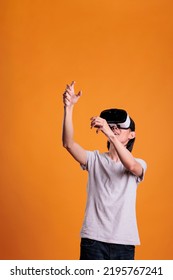 Man In Vr Headset Playing Virtual Reality Games In Metaverse. Person In Ar Goggles Enjoying Augmented Simulation Experience, Cyberspace Entertainment, Modern Lifestyle And Pastime