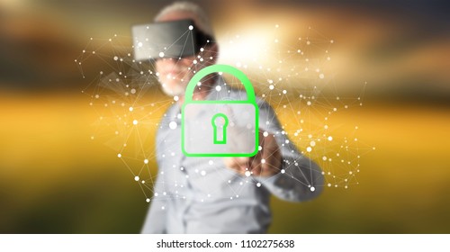 Man with vr headset touching a data security concept on a touch screen with his finger