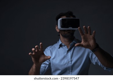 Man in VR headset. Man using VR glasses for online game. Handsome man using virtual reality headset. man experience virtual reality via VR headset and touching something with hands. - Powered by Shutterstock