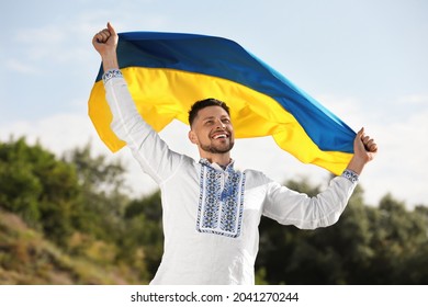Man In Vyshyvanka With Flag Of Ukraine Outdoors