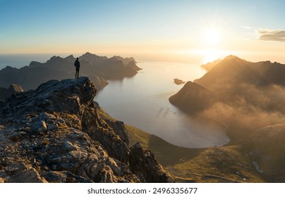 A man wachting the midnightsun from summit Keipen on Senja, Norway. - Powered by Shutterstock