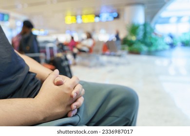 Man waiting for flight in airport departure area at airport waiting the flight.