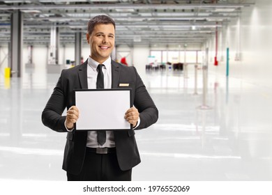 Man Waiting A Passenger At An Airport With A Name Board 