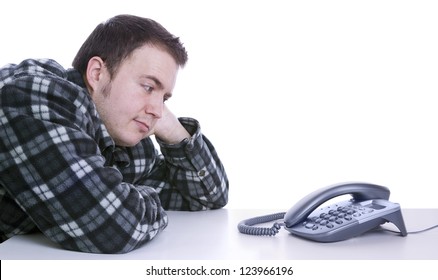 Man Waiting For Phone To Ring On Desk With White Background