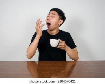 Man Wake Up At Morning St At Table Yawn And Hold Coffee Cup In Hand