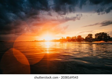 Man Wake-boarding On Lake At Sunset. Wake-boarder Skiing On Lake Behind A Boat.