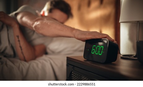 Man Wakes Up and Turns off Alarm Clock. Early Rising Productive Man Ready Start a Day full of New Business Projects, Adventures. Focus on Clock Showing Six O'Clock. Sun is Shining. bedroom Apartment