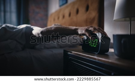 Man Wakes Up and Turns off Alarm Clock. Early Rising Productive Man Ready Start a Day full of New Adventures. Bedside Nightstand Focus on the Clock Showing Four O'Clock. Bedroom Apartment