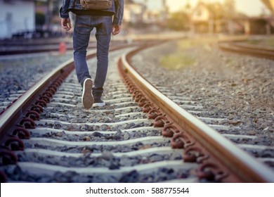 Man walk away on railroad with warm light.Selective focus.Traveler man on railroad. - Powered by Shutterstock