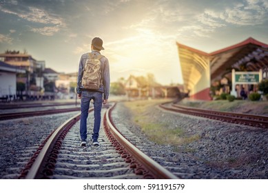 Man Walk Away On Railroad With Warm Light.Selective Focus.Traveler Man On Railroad.