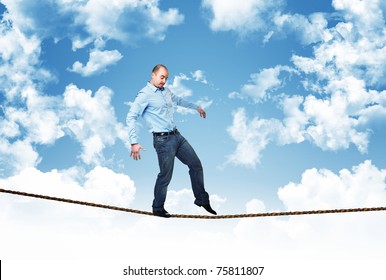 man walk on rope with blue sky background