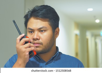 Man With A Walkie Talkie Or Portable Radio Transceiver For Emergency Response Plan