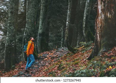 Man walking alone in deep forest Travel healthy active lifestyle adventure vacations outdoor exploring wilderness - Powered by Shutterstock