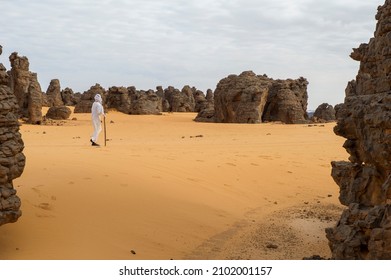 Man Walking Alone In Libyan Desert 