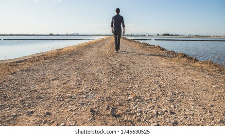 Man walking back to back on a path