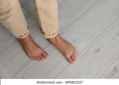 Man walking barefoot at home, closeup. Floor heating concept