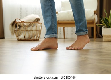 Man Walking Barefoot At Home, Closeup. Floor Heating Concept