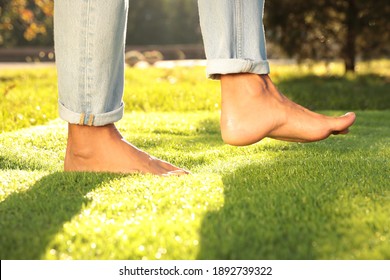 Man Walking Barefoot On Fresh Green Grass, Closeup