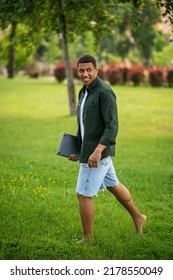 Man Walking Barefoot On Grass Sideways To Camera