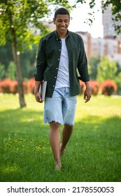 Man Walking Barefoot On Grass In Park