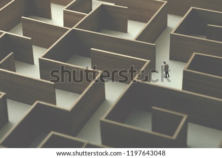 man walking in a big complex labyrinth, surreal concept