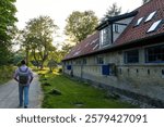 Man walking by the old historic military building in Freetown Christiania at sunset. Copenhagen, Denmark.