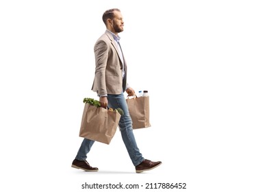 Man walking and carrying two grocery bags isolated on white background - Shutterstock ID 2117886452