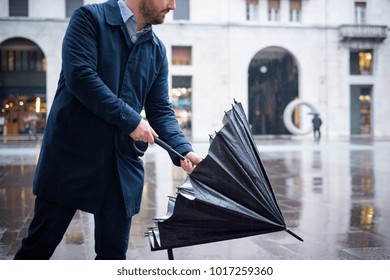 Man Walking In The City With Umbrella On Rainy Day