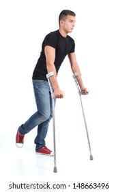 Man Walking With Crutches Isolated On A White Background              