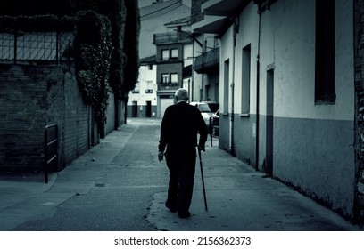 Man walking dark town street, active old age, retirement - Powered by Shutterstock