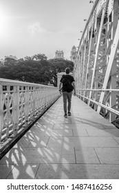Man walking down a bridge