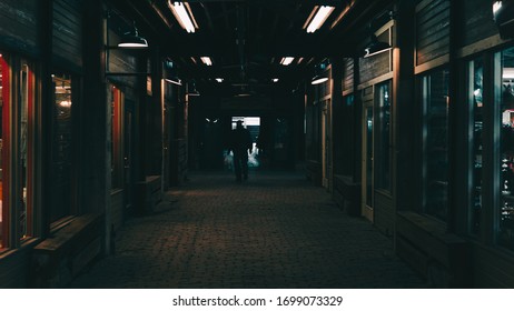 Man Walking Down Dark Alleyway