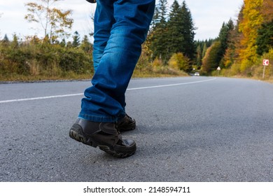 Man walking down on a forest road.
