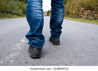 Man walking down on a forest road.
