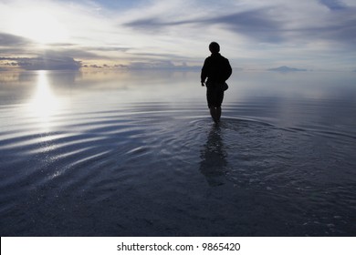 a man walking in to heaven in a uyuni salt lake bolivia - Powered by Shutterstock