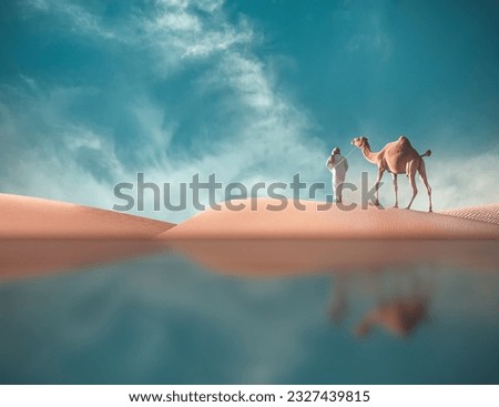 man walking with his camel in desert