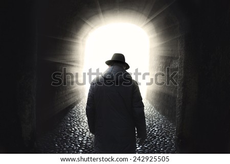 Man walking into light 