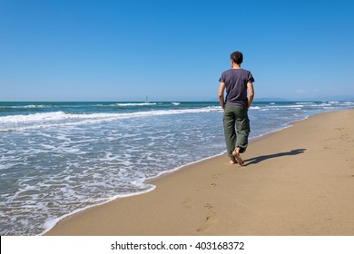 Man Walking On The Beach