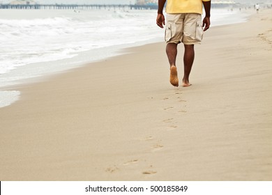 Man Walking On The Beach.