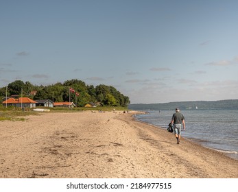 Man Walking On The Beach At Høl, Vejle, Denmark, August 1, 2022